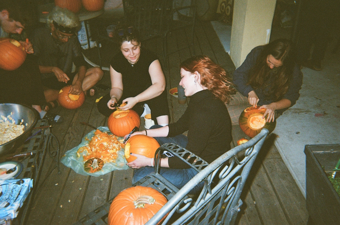 wolves (co-opers who live at Wolf) carving pumpkins on the deck